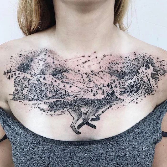 grey top, rose chest tattoo, wolf mountains trees and stars large tattoo, white background