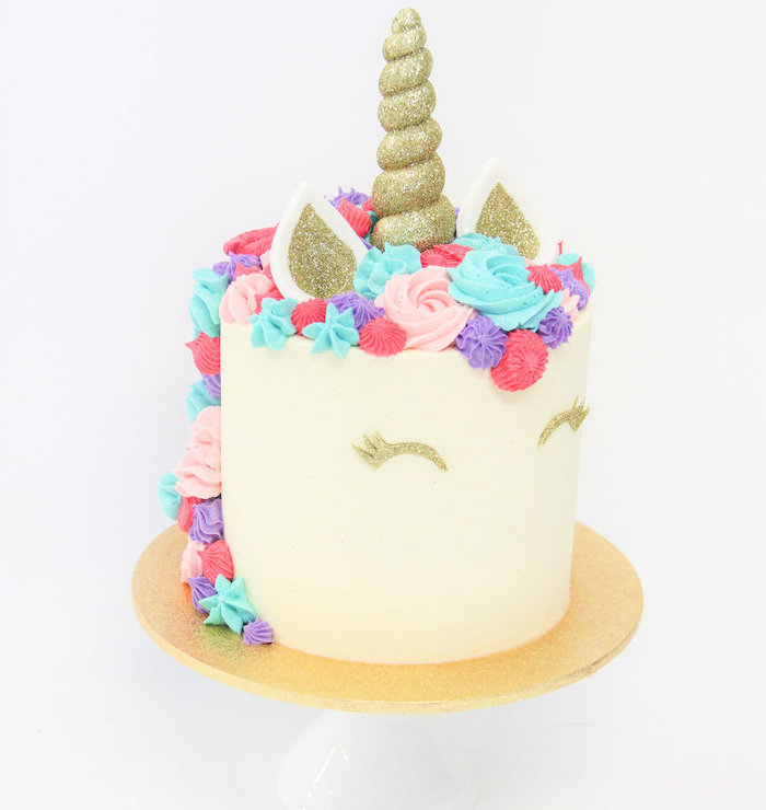 gold sprinkled horn and ears, diy unicorn cake, blue pink and red roses on white fondant