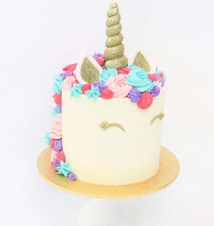gold sprinkled horn and ears, diy unicorn cake, blue pink and red roses on white fondant