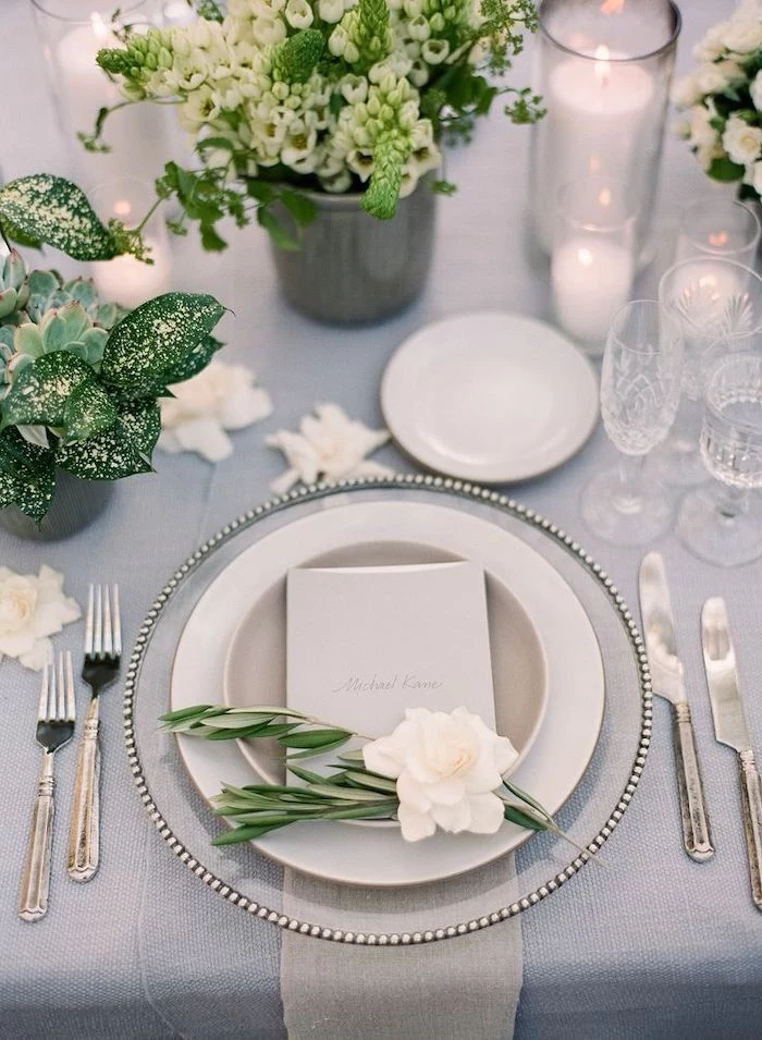 dinner set of plates and glasses, vases with white flower bouquets, outdoor wedding ideas