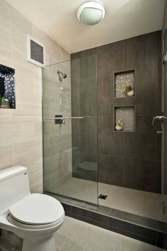grey tiled walls and floor, built in shelves, how to decorate a bathroom, glass shower door