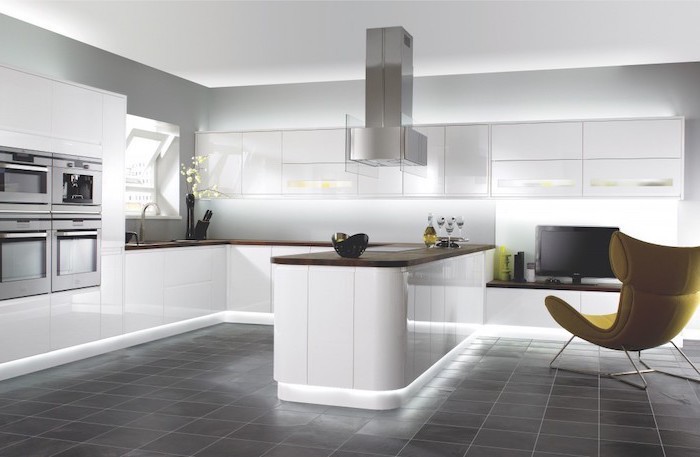 white cabinets and drawers, grey tiled floor, yellow armchair, modern kitchen ideas