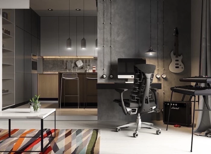 dark grey walls, black wooden desk with black chair, music instruments, colourful rug, small home office ideas