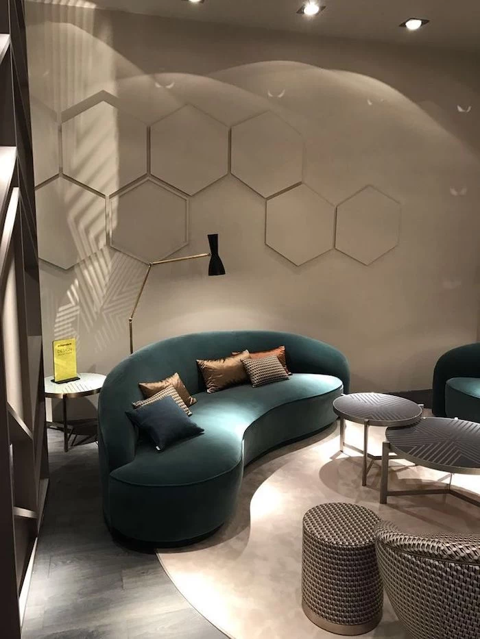 honeycomb geometrical wall installation, wall designs, turquoise velvet sofa, standing light