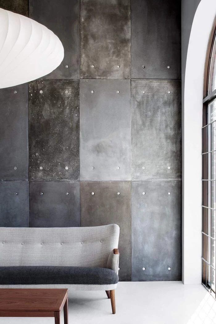 grey and black sofa, wall painting ideas, industrial metal tiles on the wall, wooden coffee table