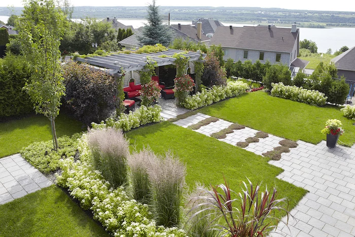 large patches of grass, tall trees, rock landscaping ideas, flower beds, tall bushes and hedges