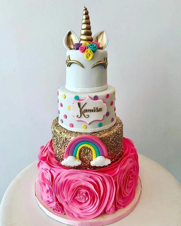large pink roses, gold layer with rainbow, unicorn cake pictures, gold horn and ears