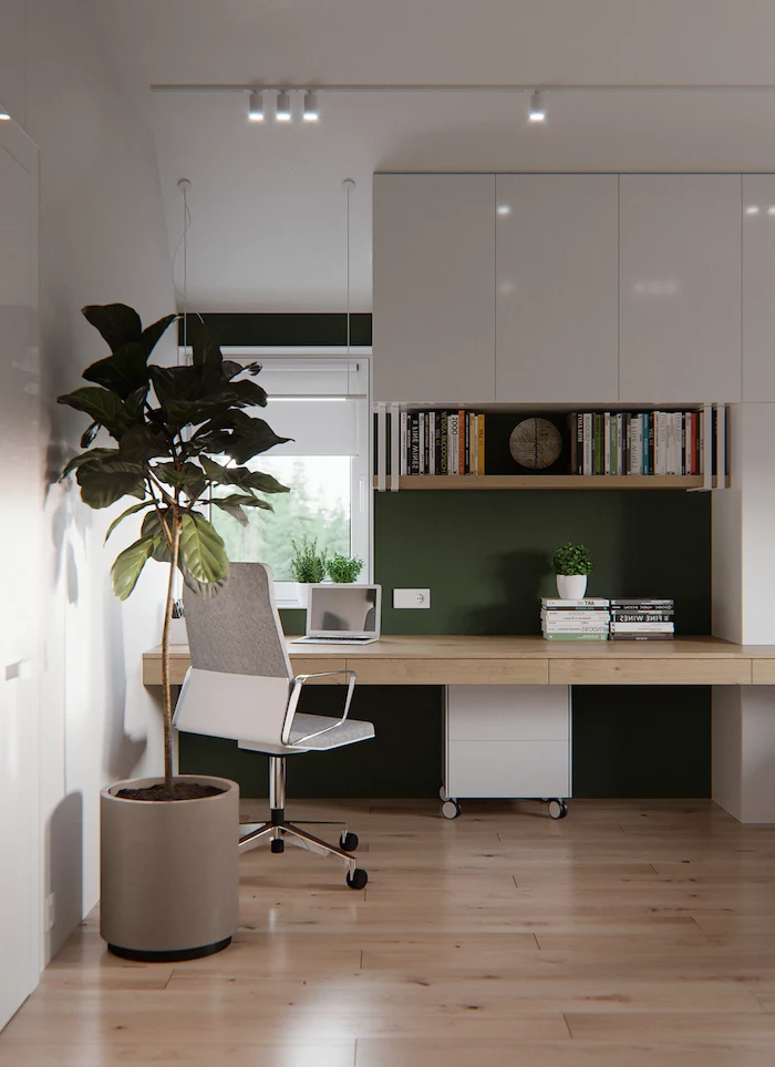white cupboards, home office decor, wooden bookshelf and desk, white and grey chair, large plant in a pot