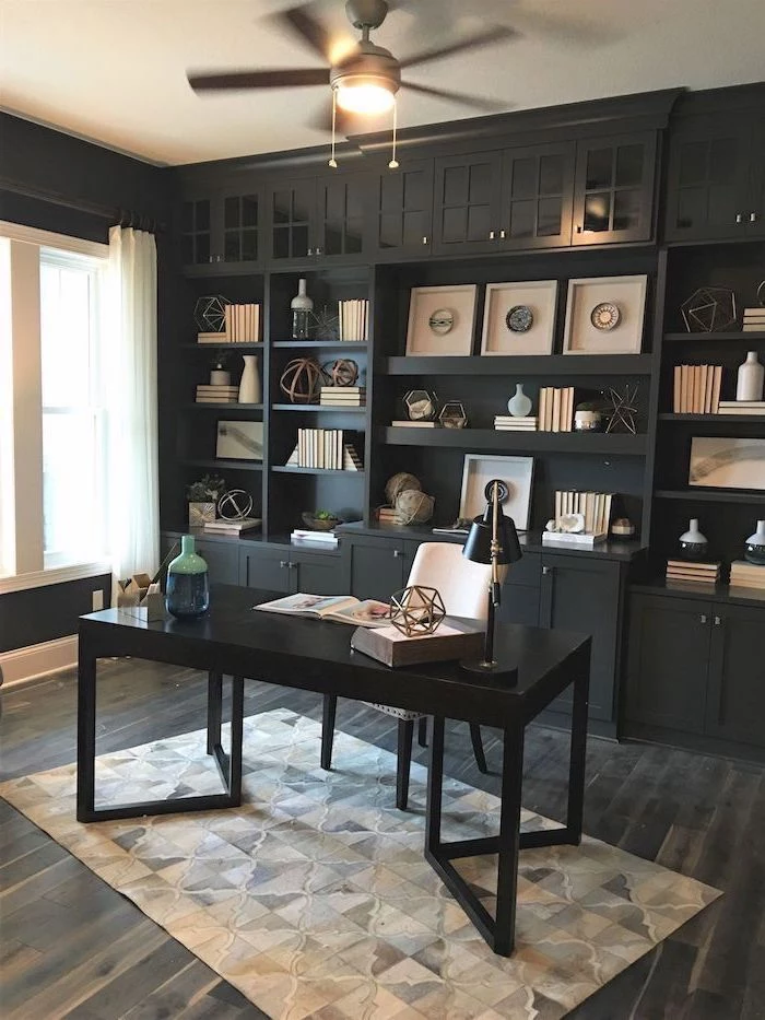 large black bookcase with cupboards and shelves, black desk with white chair, home office decor