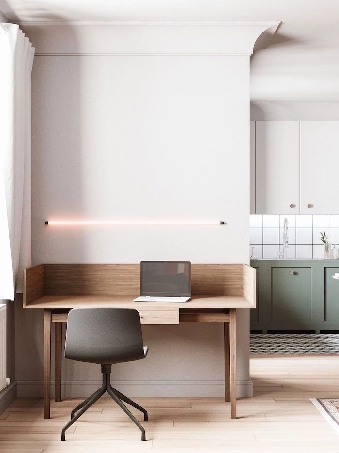 white walls, wooden desk with a laptop, led light above the desk, office design ideas, black chair
