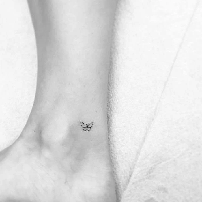 butterfly tattoo on the ankle, white background, back tattoos for girls