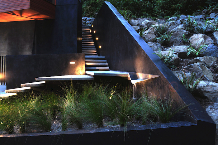 minimalistic staircase with lights, small patch of bushes, small front yard landscaping ideas, large rocks