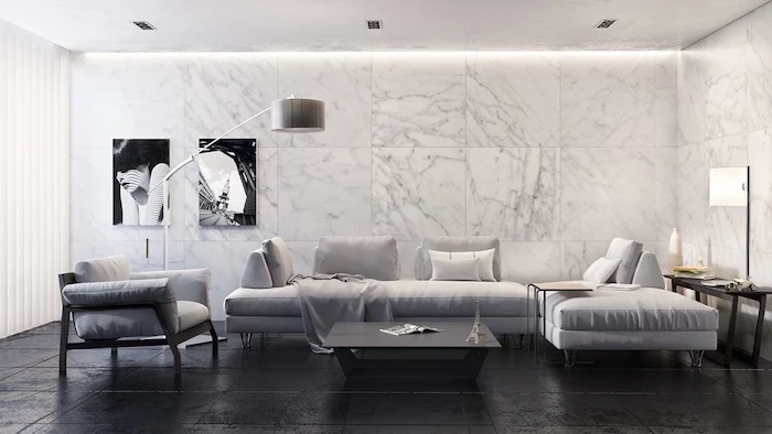 marble tiles on the wall, grey corner sofa and armchair, black floor, wall painting ideas