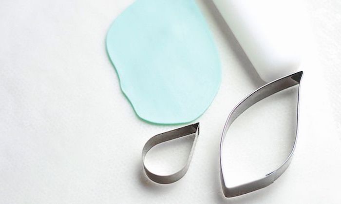 white background, metal cookie cutter shapes, how to make a unicorn horn, blue fondant