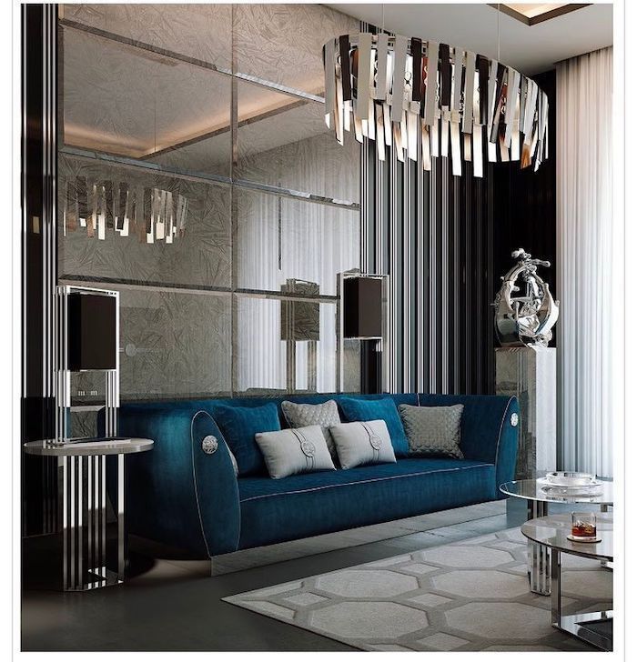 blue velvet sofa, mirror tiles wall, hanging chandelier, best color for living room walls