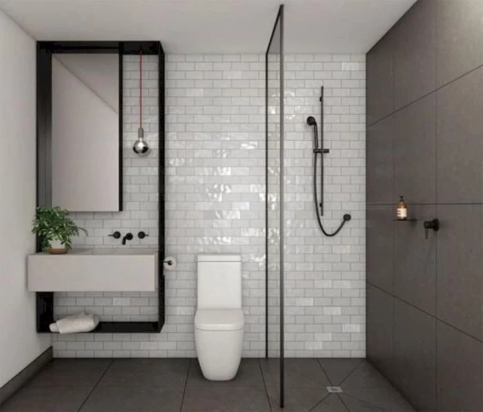 grey and white tiled walls and floor, floating white sink, small bathroom layout, small mirror