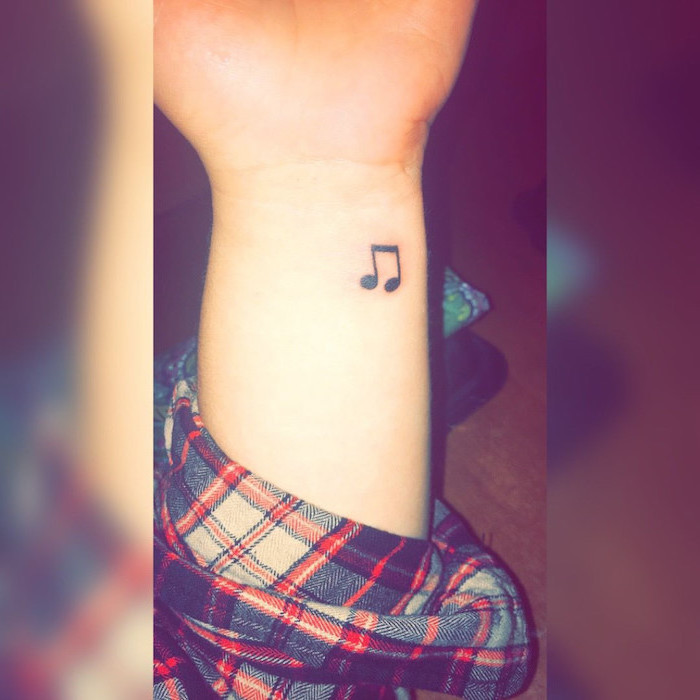 musical note, tattoo on the wrist, plaid shirt, unique tattoos, blurred background