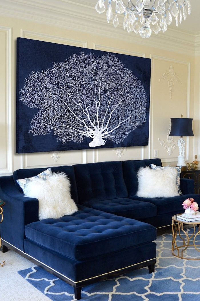 white patterned framed wall, navy blue velvet sofa, blue and white tree painting, feature wall, blue rug