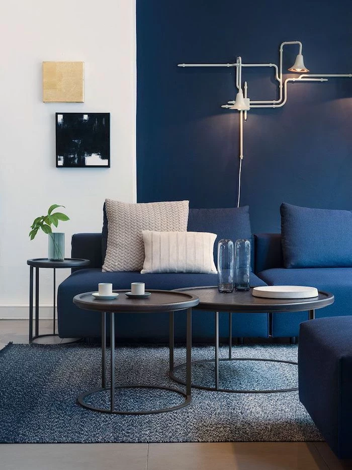 blue and white wall, lamps mounted on the wall, feature wall, round coffee tables