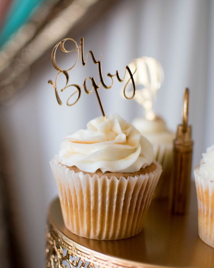 oh baby cake topper, small cupcakes, golden cake stand, sports themed baby shower