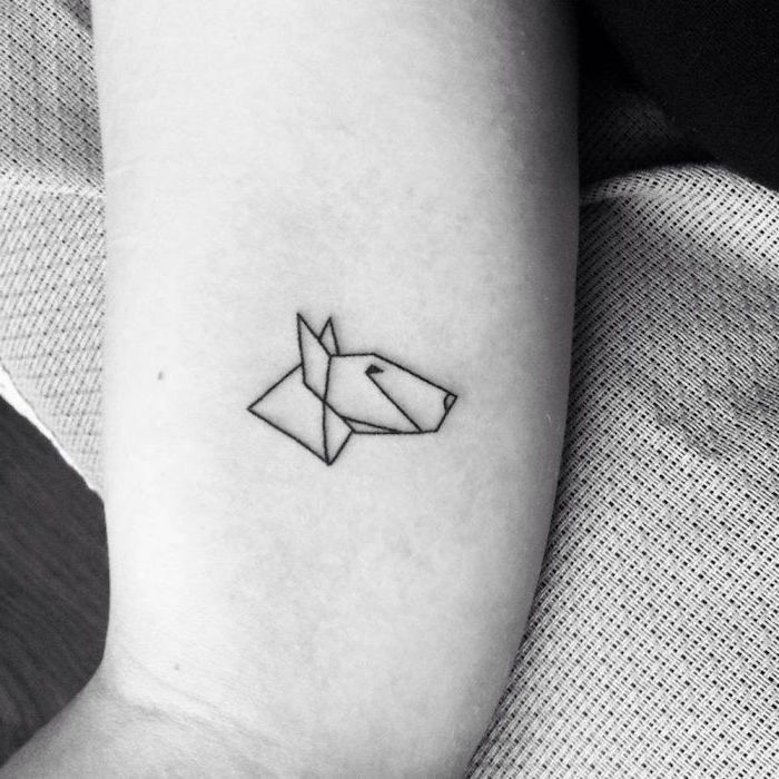 geometrical dog tattoo, white and wood background, tattoos for girls on wrists