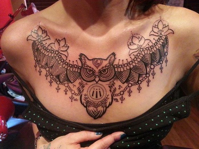 large symmetrical owl and lotuses tattoo, tattoos for girls with meaning, black top with blue dots