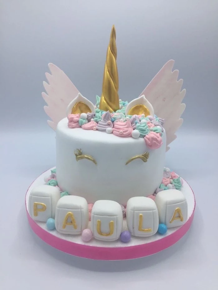 gold horn eyes and ears, unicorn cake pictures, pink wings, pink purple and green roses on white fondant
