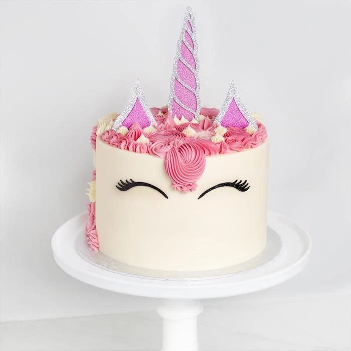 pink and silver horn and ears, pink and yellow roses on white fondant, how to make a unicorn