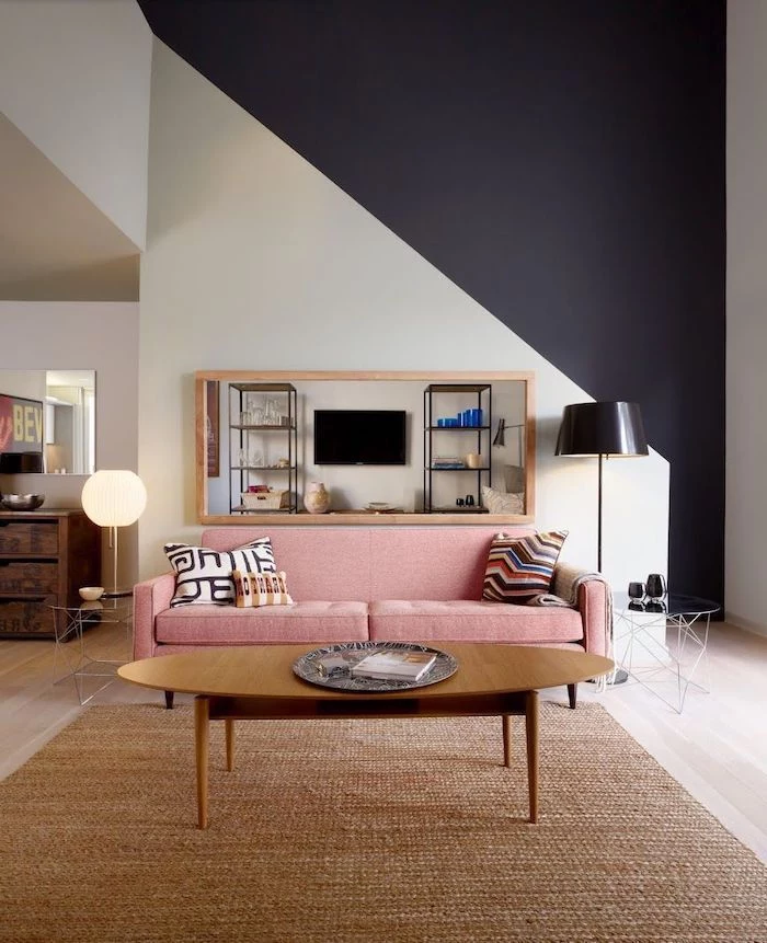 white and black geometrical wall, pink sofa, beige rug, wall designs