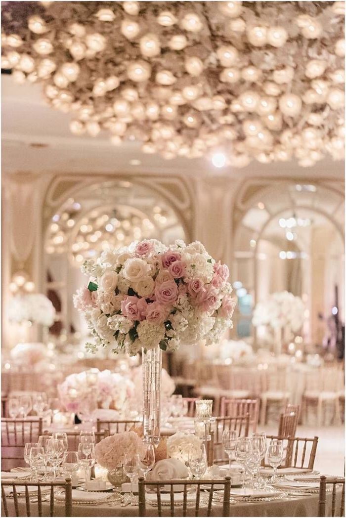 pink and white flower bouquet in a high vase, round tables with dinner sets, outdoor wedding ideas