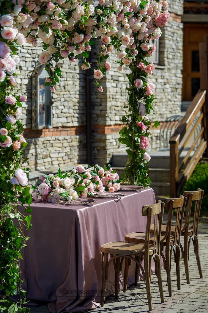 arch made of pink roses, pink and white roses flower arrangement on the table, wedding ceremony decorations