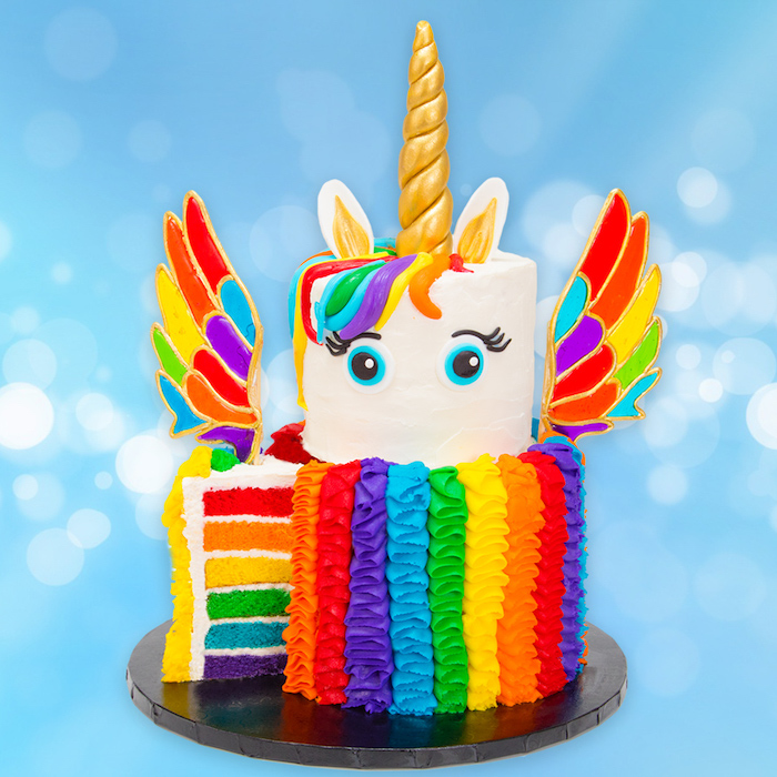 rainbow layered cake, unicorn cake ideas, rainbow coloured wings and roses, gold horn and ears