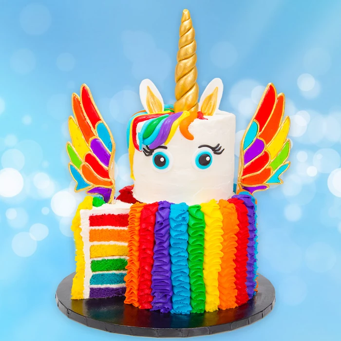 rainbow layered cake, unicorn cake ideas, rainbow coloured wings and roses, gold horn and ears