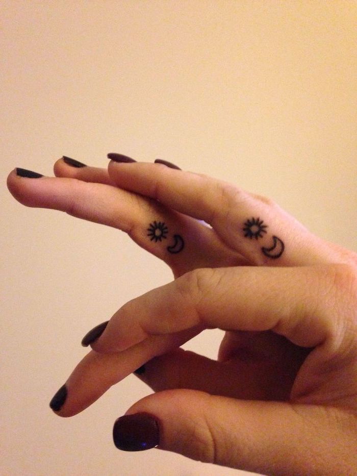 sun and moon tattoos on the fingers, red and black nail polish, chest tattoos for females