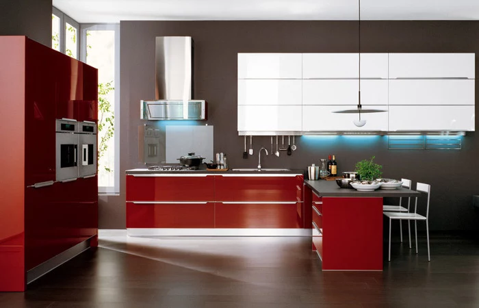 red cabinets and drawers, white cabinets, black counters, kitchen island decor, wooden floor