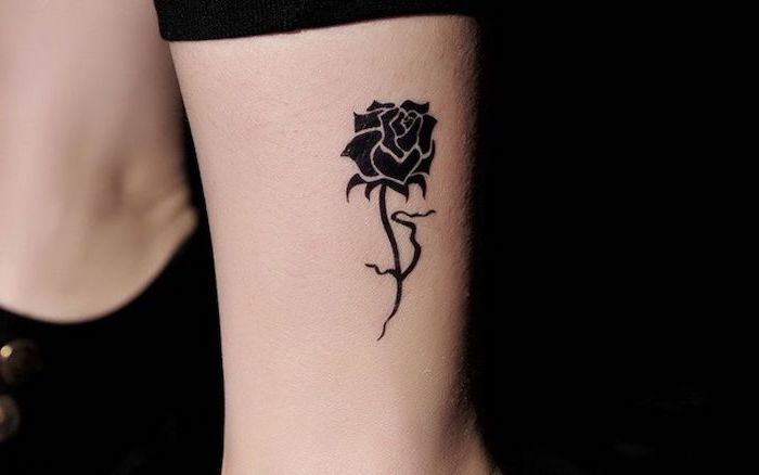 rose tattoo on the ankle, unique tattoos, black background