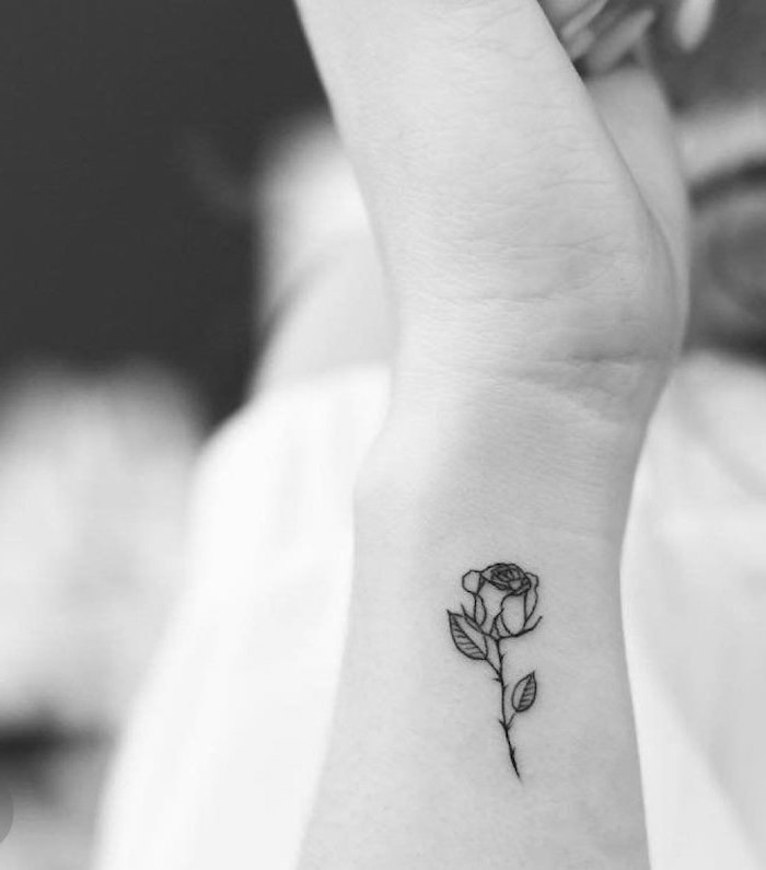 rose tattoo on the wrist, tattoos for girls on wrist, blurred background