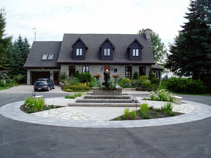 roundabout driveway, small fountain in the middle, desert landscaping ideas, small flower beds with lights
