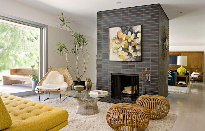 shades of grey tiles with an abstract painting, yellow sofa, accent wall ideas bedroom, wooden armchair and stools
