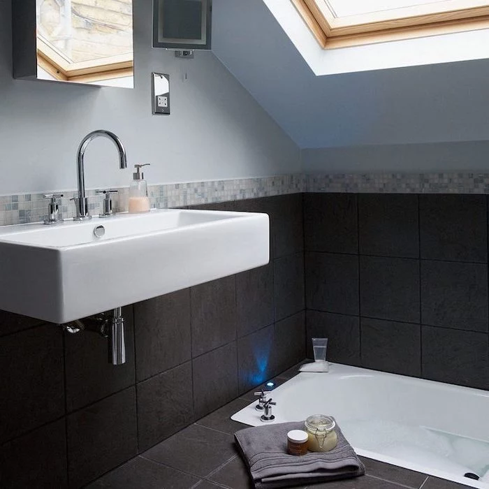 blue walls and black tiled floor, sinking bathtub, bathroom designs for small spaces, floating sink