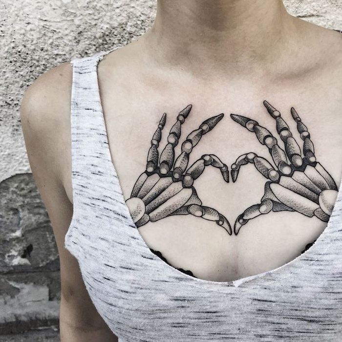 skeleton hands, heart shaped tattoo, tattoos for women, small chest tattoos for ...