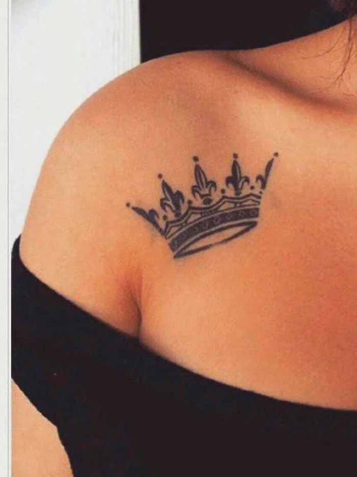 crown tattoo on the shoulder, tattoos for women, black top, black and white background