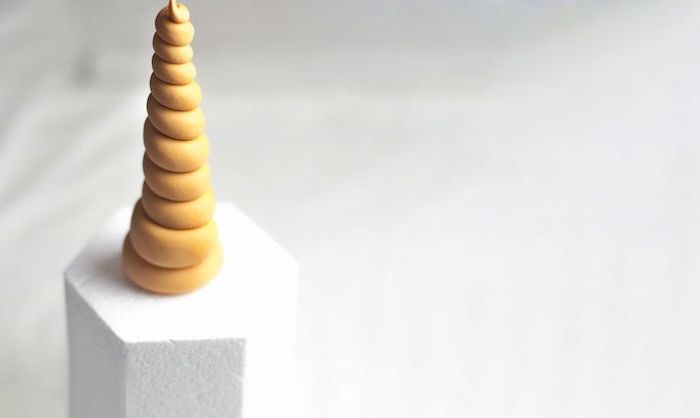 unicorn birthday cake, gold horn on white styrofoam, white background