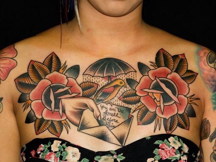 unique tattoos for women, hand holding an envelope, bird with an umbrella, two large flowers