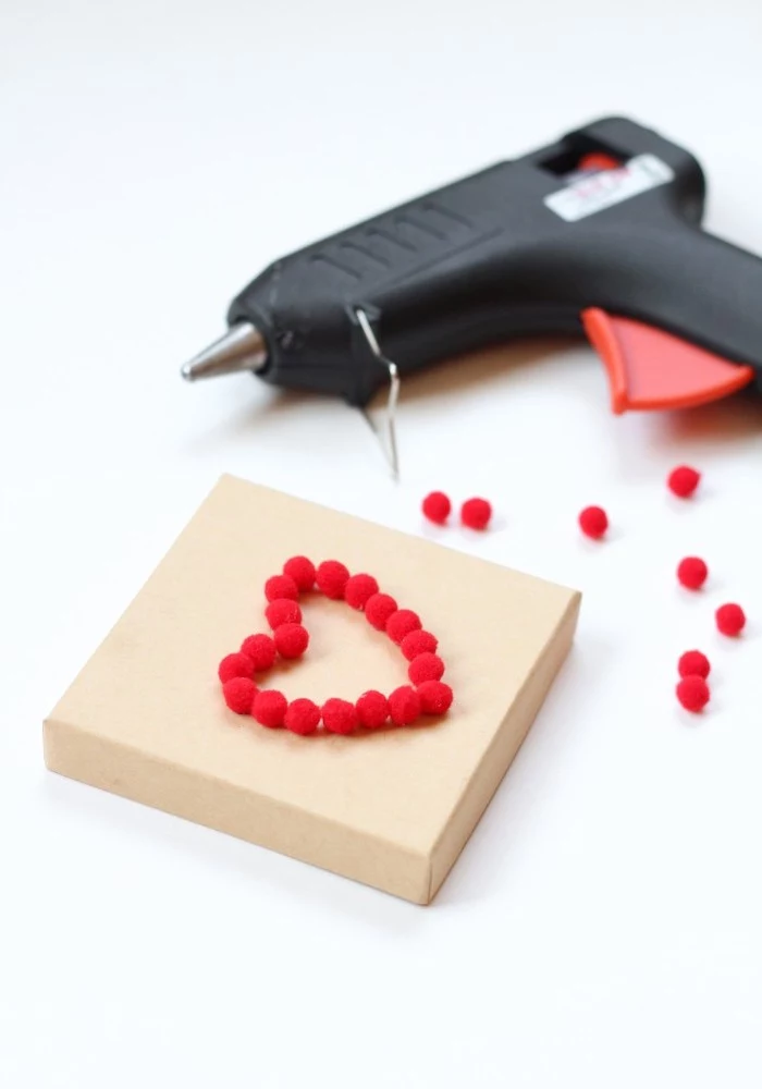 glue gun, heart shaped pom poms, cardboard box, gift basket ideas for boyfriend