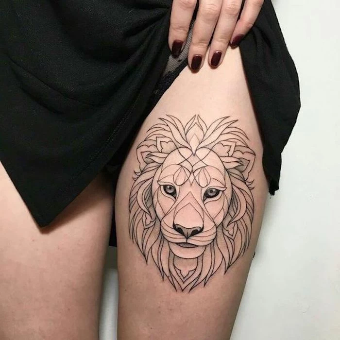 geometrical lion head, red nail polish, meaningful tattoo ideas, black dress, white background, thigh tattoo