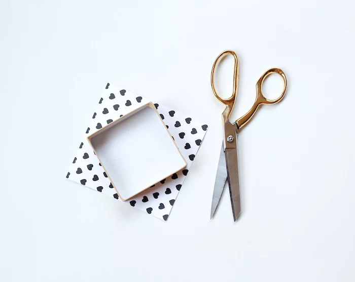 gold scissors, cardboard box covered with heart-shaped printed paper, diy gifts for boyfriend
