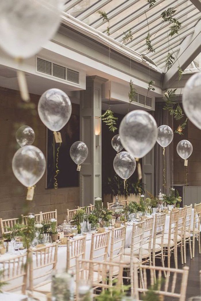 white balloons, green flower bouquets in vases on the table, wedding ideas for spring