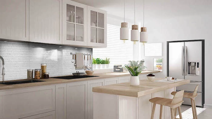 white brick backsplash, kitchen cabinets pictures, wooden counters and stools, white cabinets and drawers