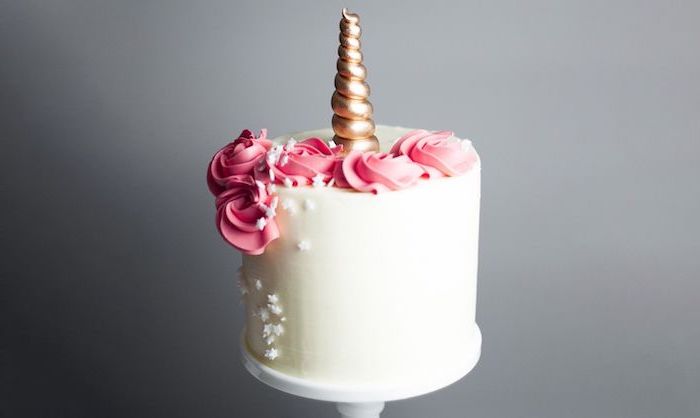 unicorn cake ideas, white cake stand, gold horn, white star sprinkles, red roses on white fondant